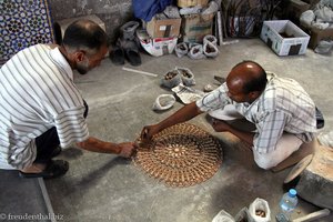 ein ganzen tag sind zwei Männer damit beschäftigt, ein Mosaik zu legen.
