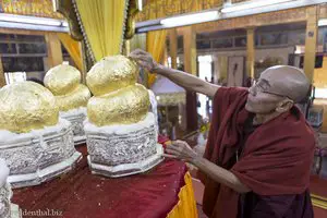 Mönch klebt Blattgold auf die Buddha-Figuren - Phaung Daw U Pagode