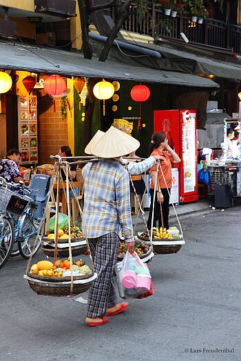Verkäufer mit Tragejoch in der Altstadt Hội An