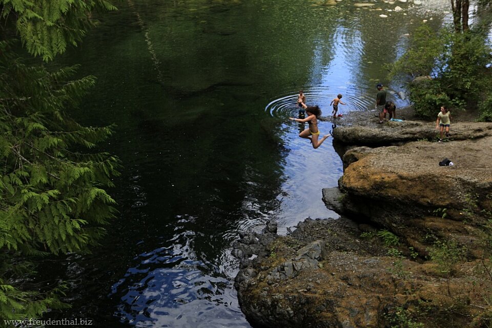 Kinder springen in den kalten Englishman River auf Vancouver Island.