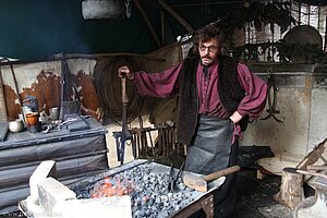 Schmied auf dem historischen Weihnachtsmarkt im Stallhof