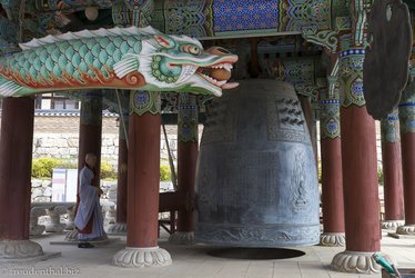Mönch schlägt die Glocke beim Haeinsa Tempel
