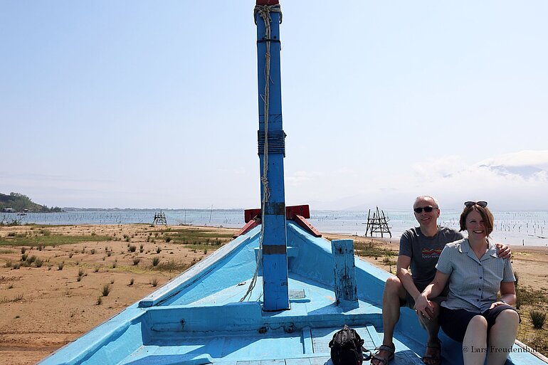 Urlauber auf einem alten Fischerboot in der Bucht Vụng An Cư